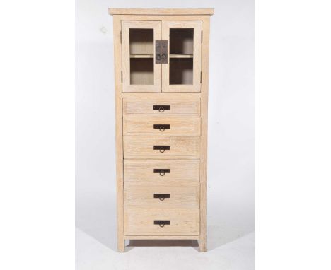 A contemporary limed oak storage cabinetWith a slab top above two glazed doors enclosing a single shelf over six thumb moulde