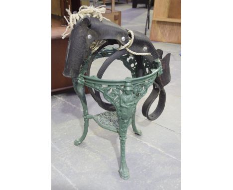 A green painted cast iron garden tableOf typical classical tripod form, lacking top together with a horse tyre and  rope swin
