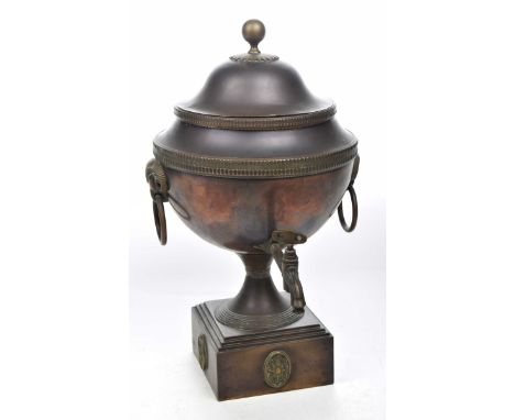 A 19th Century copper alloy and brass SamovarThe stepped square section pedestal base extending to a short splayed foot risin