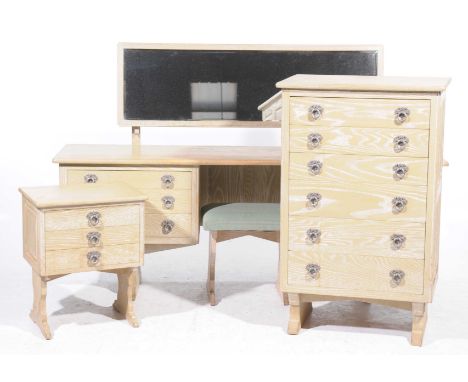 A mid 20th Century limed oak four piece bedroom suiteComprising a dressing table with a long rectangular mirror and six drawe