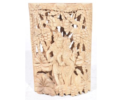 A 20th Century South East Asian carved and fret work hardwood wall plaque Depicting young couple in jungle scene, 50cm high. 