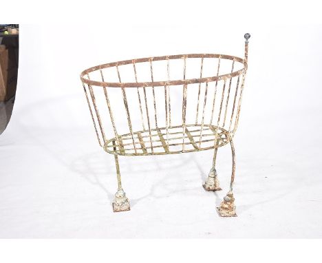 A vintage cast iron manger
The openwork basket raised on three stepped tripod legs with good all over white painted patinatio