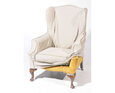 A Georgian style wing back fireside armchair, early 20th CenturyPadded wing backs and scroll arms enclosing a loose cushion s