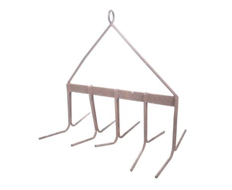 A vintage cast iron farm implement/kitchen pot hangerThe tubular frame work with ten arched spokes hanging from a loop trifor