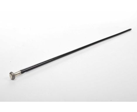 A late Victorian ebonised gentleman's walking caneThe tapered ebonised stick surmounted by a white metal ferrule with chased 