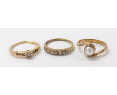Diamond solitaire ring with set shoulders, marked '11k'; 9ct fancy and white diamond ring and a 9ct cultured pearl ring,  7.8