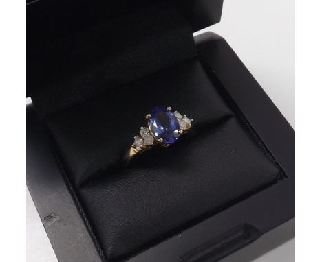Tanzanite and diamond 14k ring, the oval tanzanite estimated 1.65ct approx, with three round brilliant-cut diamonds to either