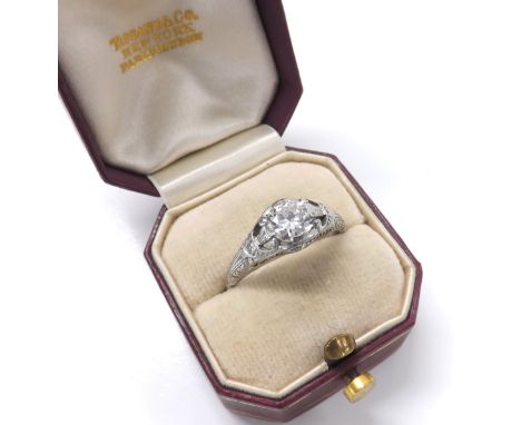 Tiffany &amp; Co. - good quality platinum diamond ring, round brilliant-cut with pierced set shoulders and two small inset di