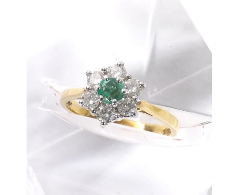 18ct emerald and diamond seven stone cluster ring, with a single diamond in a surround of six round brilliant-cut diamonds, 0