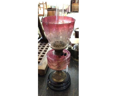 Edwardian Duplex oil lamp, with brass central column and cranberry glass resavouir with etched cranberry glass shade, 57cm in