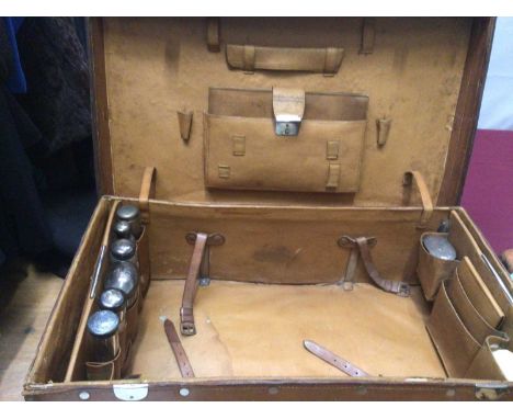 Vintage brown leather suitcase with fitted interior containing silver topped glass jars and other travelling items, H B Drew 