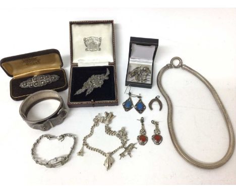 Victorian silver cuff bangle, silver necklace, two silver and marcasite brooches, silver charm bracelet, various loose charms