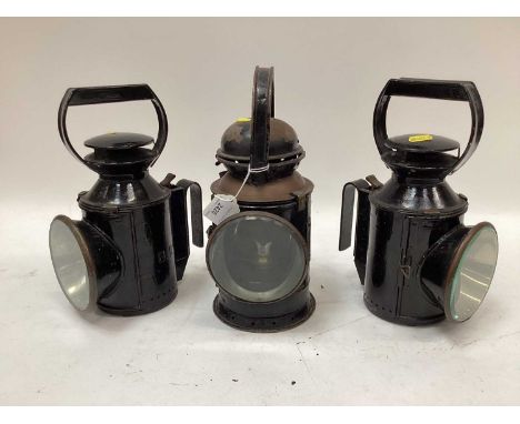 Three vintage black-painted railway lamps
