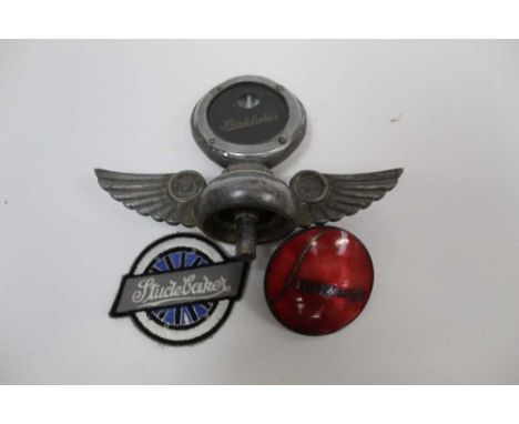 Studebaker bonnet mascot / radiator cap, together with a Studebaker enamel badge and cloth badge (3)