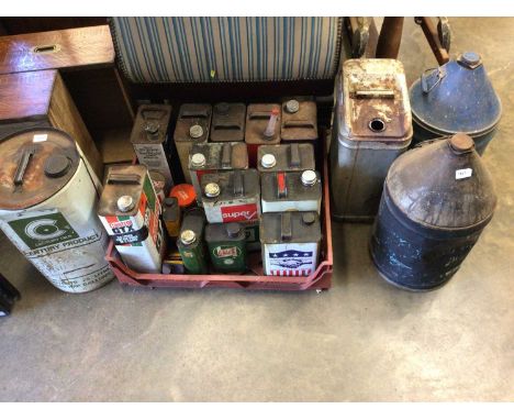 Collection of various vintage BP, Ford, Esso and other oil cans can bottles.