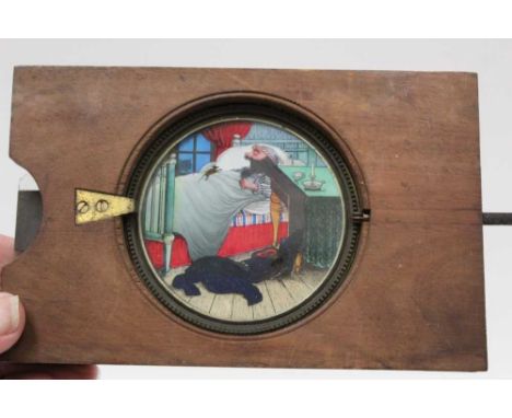Two Victorian coloured animated winding Magic Lantern slides, man in bed with mouse and man with ship's wheel.