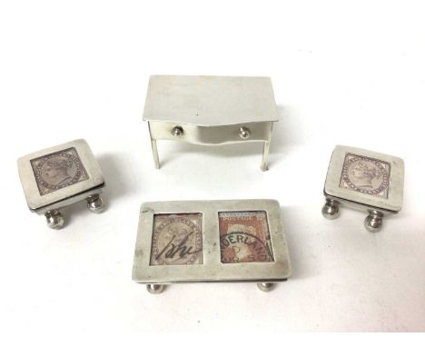 Edwardian silver trough-shaped double stamp holder (Birmingham 1906), two white metal stamp holders and novelty table stamp b