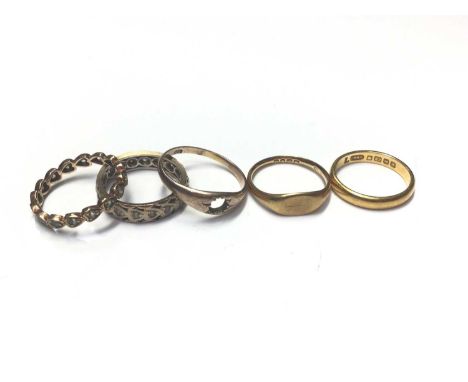 22ct gold wedding ring, size K, two 18ct gold rings and two 9ct gold eternity rings (5)22ct ring weighs 3.4 grams.Two 18ct ri