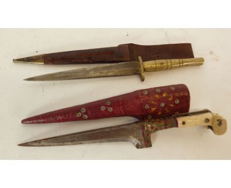 CRUDE MIDDLE EASTERN DAGGER, with two part bone handle and the red leather scabbard,  TOGETHER WITH ANOTHER DAGGER, with turn