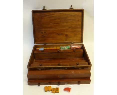 AN INTER-WAR YEARS CHINESE MAH-JONG SET WITH THERMO-PLASTIC PLAYING PIECES (three apparently deficient), contained in a hardw