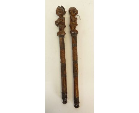 AFRICAN CARVED SOFTWOOD  BATON carved finial figure of standing male and ANOTHER A FEMALE, each 17 3/4" (45cm) high, ORIENTAL
