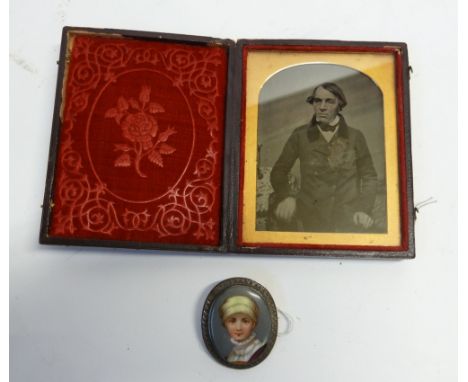 LATE 19TH CENTURY MINIATURE ON PORCELAIN OVAL BROOCH head and shoulders of a girl, in silver coloured metal frame, 2" (5.1cm)