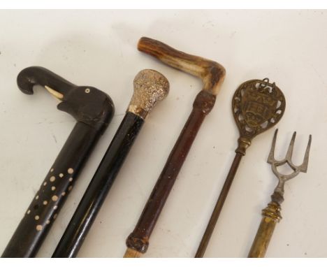EARLY TWENTIETH CENTURY EBONY WALKING CANE with silver plated embossed pommel, an  EARLY TWENTIETH CENTURY AFRICAN EBONY AND 
