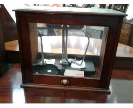 the scales contained within a mahogany case 