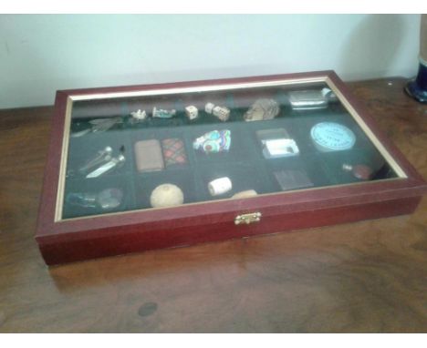 comprising cigar cutters, vesta case, dice, silver trowel bookmark and other assorted items, all contained in a curio case 