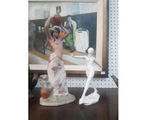depicted semi-nude in traditional dress, together with a Goebel figure of an outstretched woman 