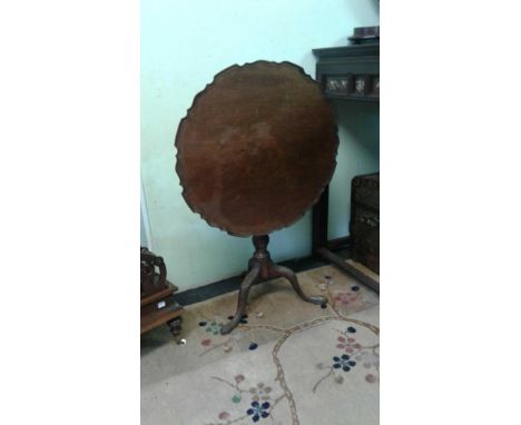 of shaped circular form with a carved cavetto top resting on a carved pillar support leading to three carved cabriole legs wi
