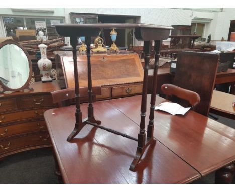 of rectangular form with turned double pillar supports and splayed feet, originally part of a nest 