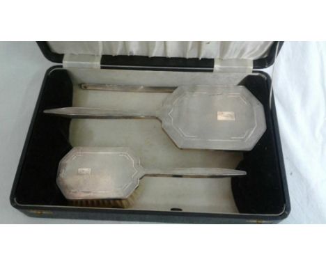 comprising of a brush and mirror with engine turned silver backs, engraved with initials, in original presentation box 