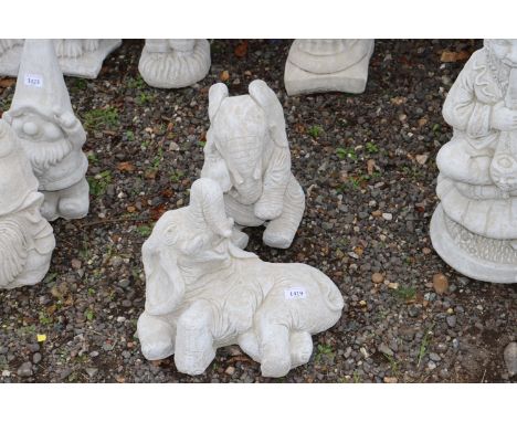 Two concrete garden ornaments in the form of elephants