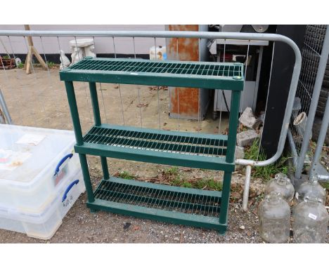 A green plastic three tier shelf