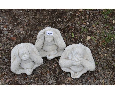 Three concrete garden ornaments in the form of orangutangs