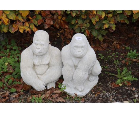 Two concrete garden ornaments in the form of gorillas