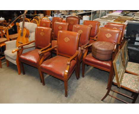 A set of ten mahogany leather upholstered dining chairs from the boardroom of BP, eight standards, two calvers