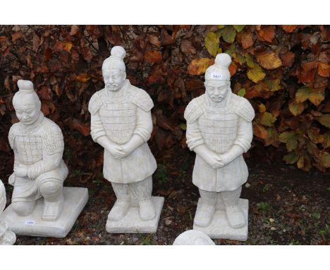 Two concrete garden ornaments in the form of warriors