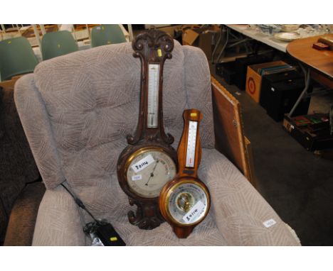 A late Victorian carved oak banjo shaped barometer by Negretti  & Zambra; and another modern mahogany barometer 