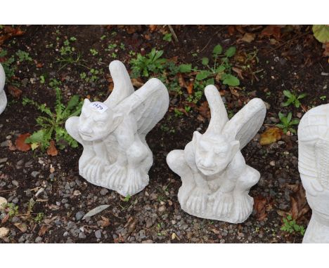 Two concrete garden ornaments in the form of gargoyles