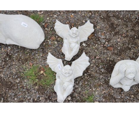 Two concrete garden ornaments in the form of gargoyles