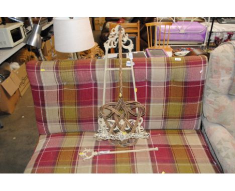 A metal easel AF; and a wicker carpet beater 