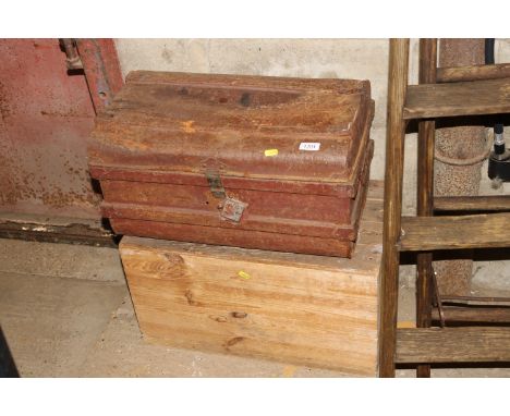 A wooden storage chest and vintage metal trunk