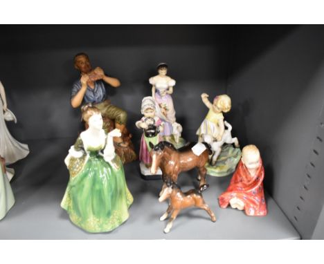 A mixed lot of figurines including Royal Doulton 'Fleur', Beswick ponies and Royal Worcester 'April'.