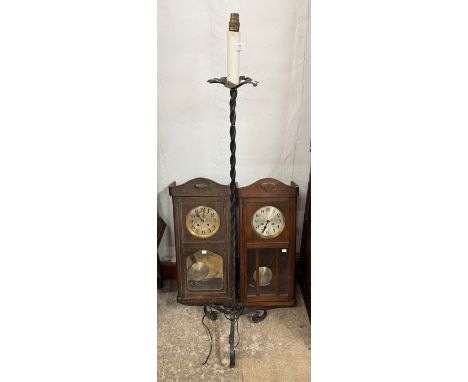 A German oak wall clock, another wall clock and a cast alloy standard lamp