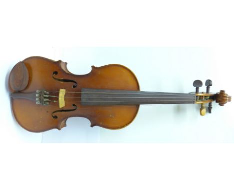 An early 20th Century violin and case, unlabelled, length of back excluding button 35.5cm, case a/f