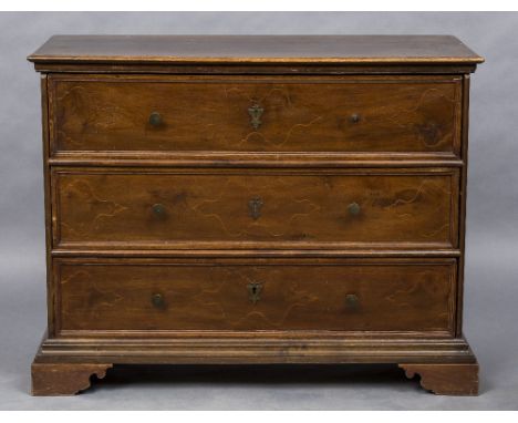 A Venetian walnut chest of drawersThe moulded rectangular top above three line inlaid drawers with brass handles and escutche