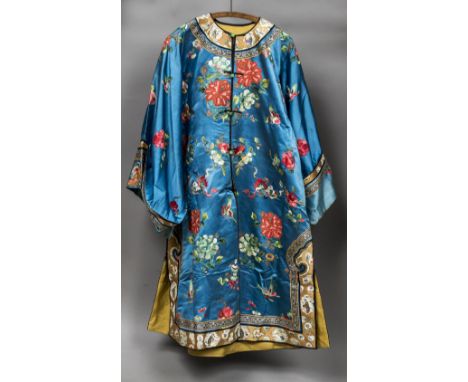A 19th century Chinese embroidered silk jacketWorked with floral sprays and insects on a sky blue ground with green jade butt