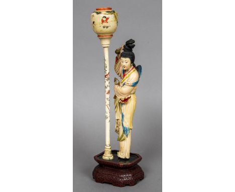 An early 20th century Chinese Republic period carved and stained ivory figureWorked as a woman holding a sword and circular b